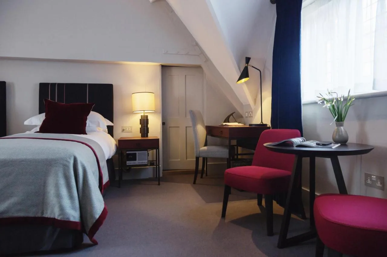A bedroom with desk and bed at Old Parsonage Hotel, Oxford